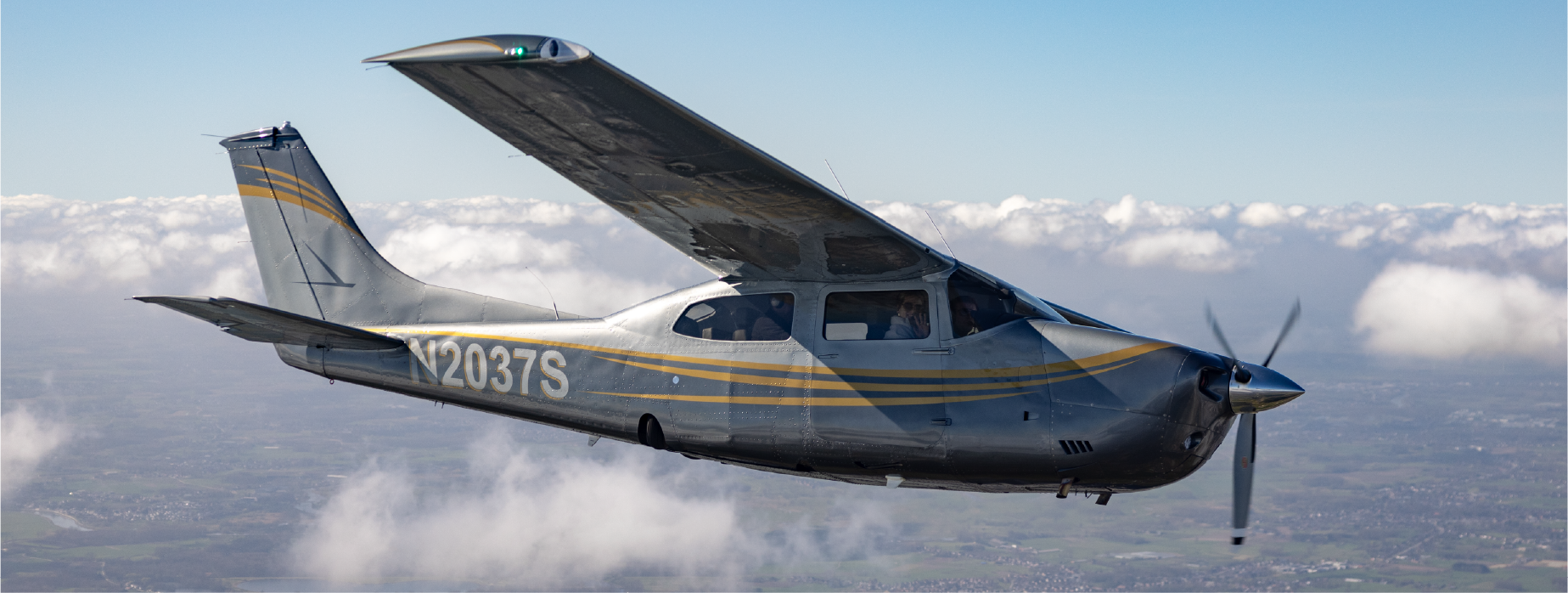 N2037S in flight above the clouds